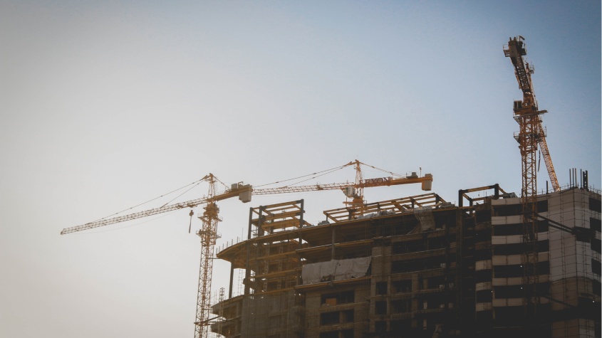 Cranes and high-rise construction site illustrating large-scale projects supported by AI document management systems.